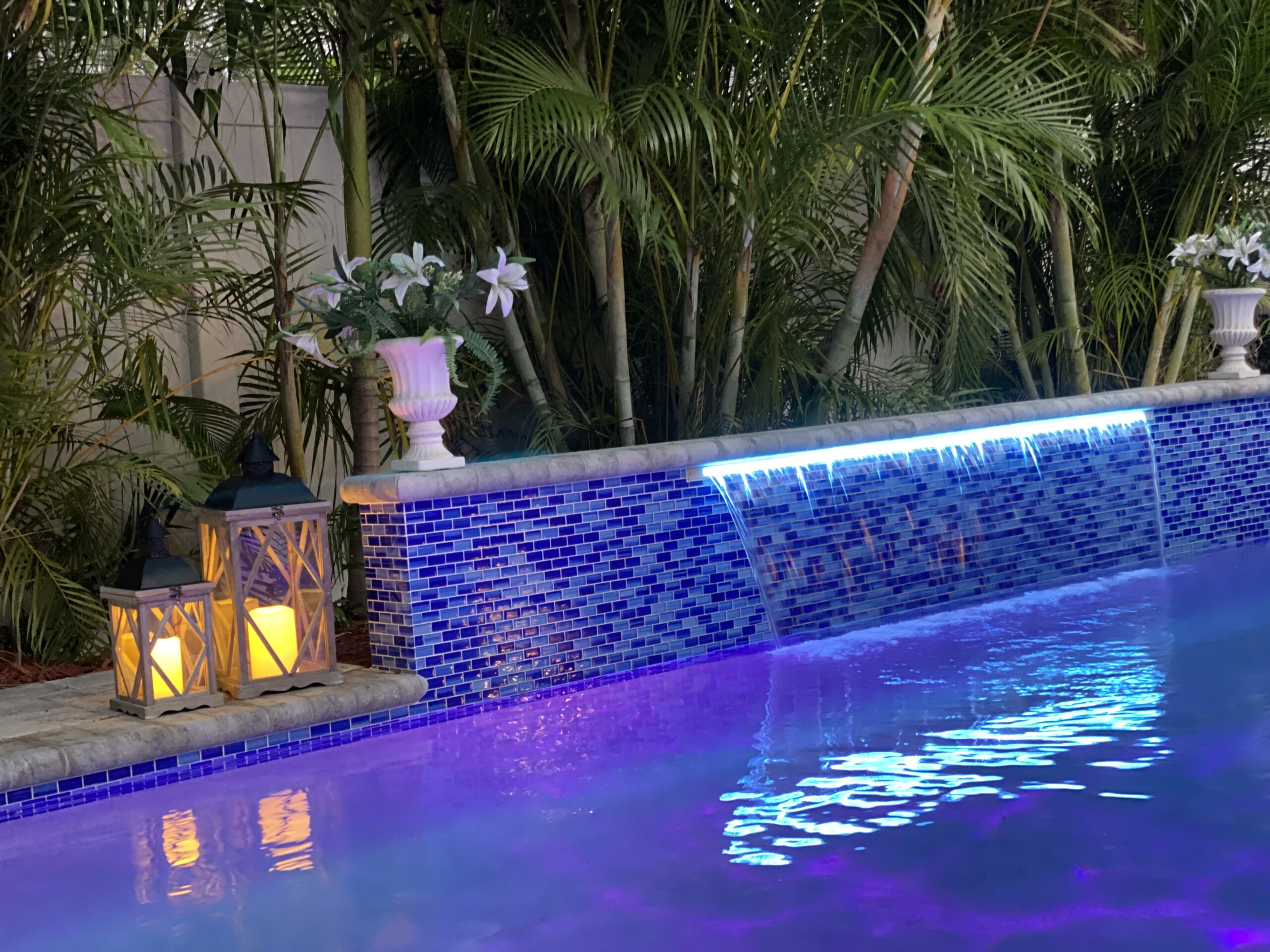 A finished Freedom Pools and Spas custom pool in Sarasota, FL — resort-style backyard at golden hour.